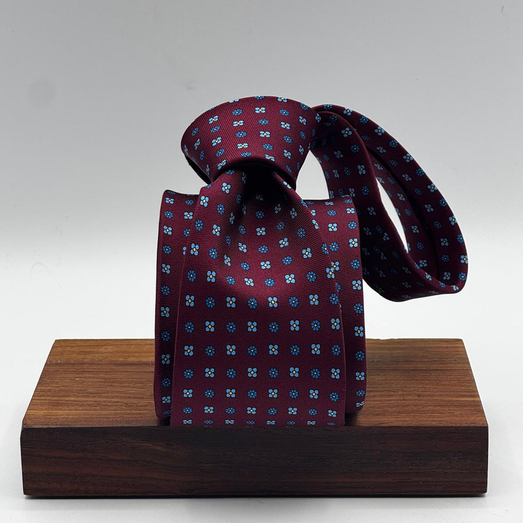 Cruciani &amp; Bella
100% Printed Silk&nbsp;
Tipped
Red Wine, Light Blue, Blue and Yellow Motif Tie
Handmade in Italy
8 cm x 148 cm
New Old Stock