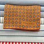 Holliday &amp; Brown
Hand-rolled&nbsp;&nbsp;
Holliday &amp; Brown for Cruciani &amp; Bella
100% Silk
Mustard, Light Brown, Red and White
Double Faces
Motif&nbsp; Pocket Square
Handmade in Italy

32 cm X 32 cm
#10335