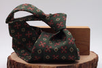 Bottle green, red and cream motif tie