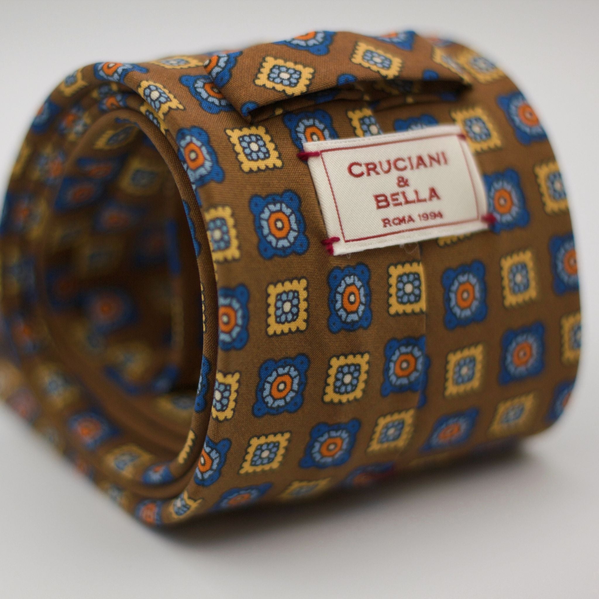 Cruciani & Bella  100% Printed Madder Silk  Italian fabric  Unlined tie Khaki, Blue, light Blue, Yellow and Orange motif Handmade in Italy 8 cm x 150 cmCruciani & Bella  100% Printed Madder Silk  Italian fabric  Unlined tie Khaki, Blue, light Blue, Yellow and Orange motif Handmade in Italy 8 cm x 150 cm