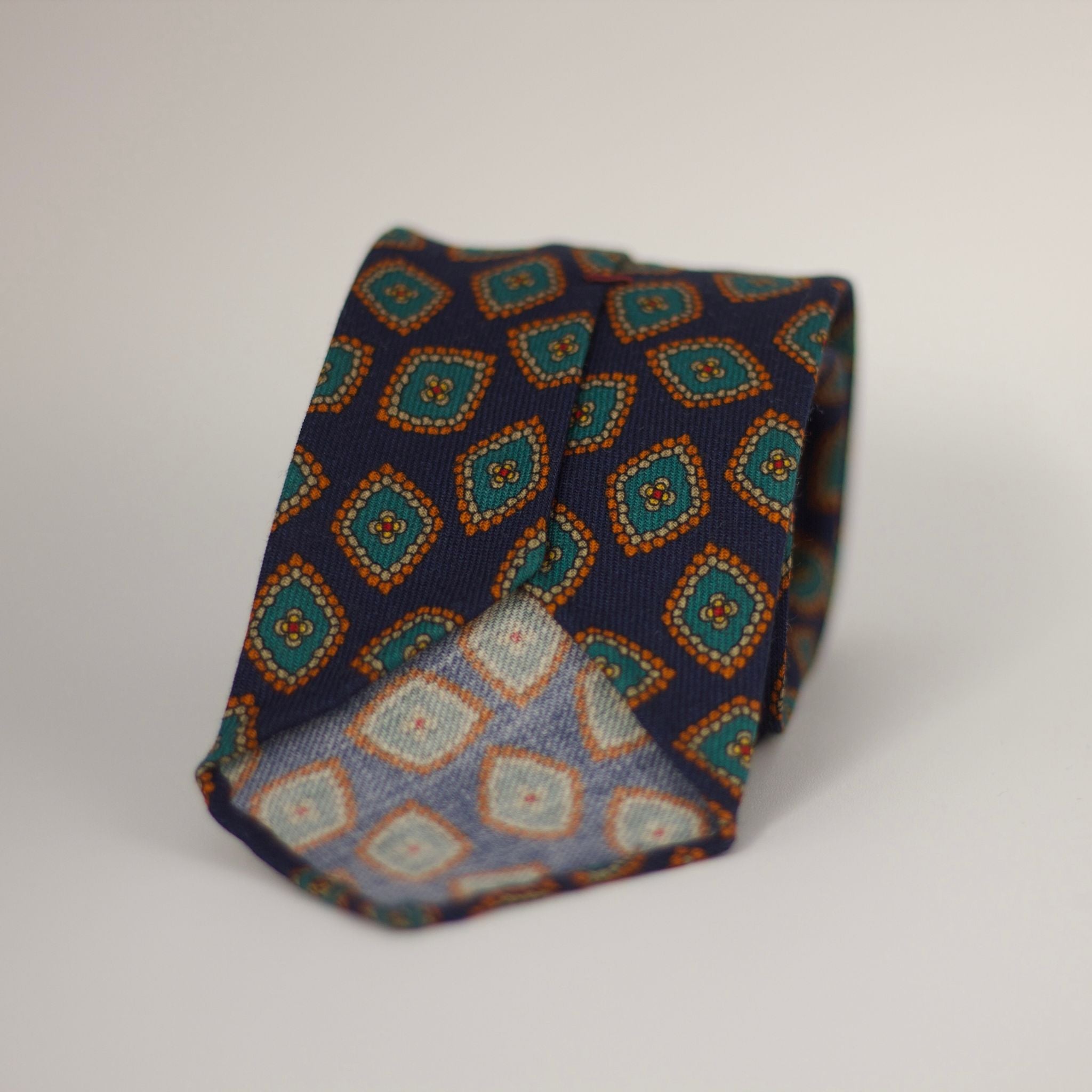 Cruciani & Bella 100%  Printed Wool  Unlined Hand rolled blades Dark Blue, Green, Orange and light beige Motif Tie  Handmade in Italy 8 cm x 150 cm #7296