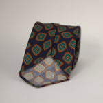 Cruciani & Bella 100%  Printed Wool  Unlined Hand rolled blades Dark Blue, Green, Orange and light beige Motif Tie  Handmade in Italy 8 cm x 150 cm #7296