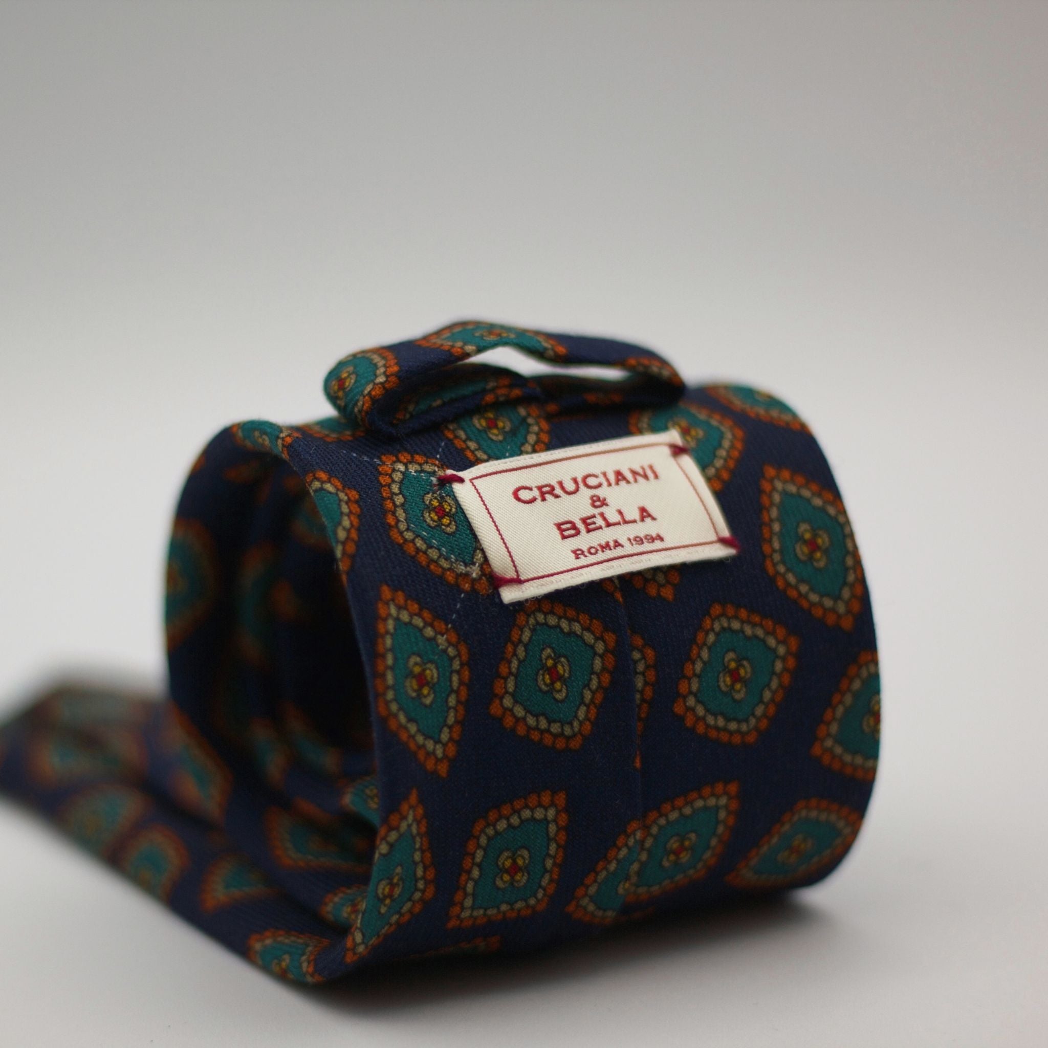 Cruciani & Bella 100%  Printed Wool  Unlined Hand rolled blades Dark Blue, Green, Orange and light beige Motif Tie  Handmade in Italy 8 cm x 150 cm #7296