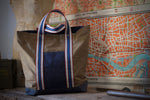 100% organic cotton - 7.5 oz ripstop cotton, 7mmx7mm - UK fabric, GOTS certified - FCF free and biodegradable fabric - Water repellent - Vegan dry wax finish - Royal blue/ Red/ Off white/ Oat handles - Belgian webbings, OEKO-TEX® Standard 100 certified - Antique brass rivets - Handcrafted, in house, in Italy, one piece at the time