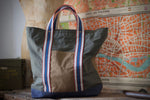 100% organic cotton - 7.5 oz ripstop cotton, 7mmx7mm - UK fabric, GOTS certified - FCF free and biodegradable fabric - Water repellent - Vegan dry wax finish - Royal blue/ Red/ Off white/ Oat handles - Belgian webbings, OEKO-TEX® Standard 100 certified - Antique brass rivets - Handcrafted, in house, in Italy, one piece at the time