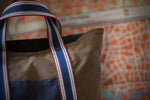 100% organic cotton - 7.5 oz ripstop cotton, 7mmx7mm - UK fabric, GOTS certified - FCF free and biodegradable fabric - Water repellent - Vegan dry wax finish - Royal blue/ Red/ Off white/ Oat handles - Belgian webbings, OEKO-TEX® Standard 100 certified - Antique brass rivets - Handcrafted, in house, in Italy, one piece at the time