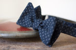 Noodles Bow Ties 100% Japanese Cotton  Blue navy, grey crosses Handcrafted in Italy Coated metal hardware  Olive green gabardine inside Hand-stitched labels Handmade boxes Self-tie bow ties